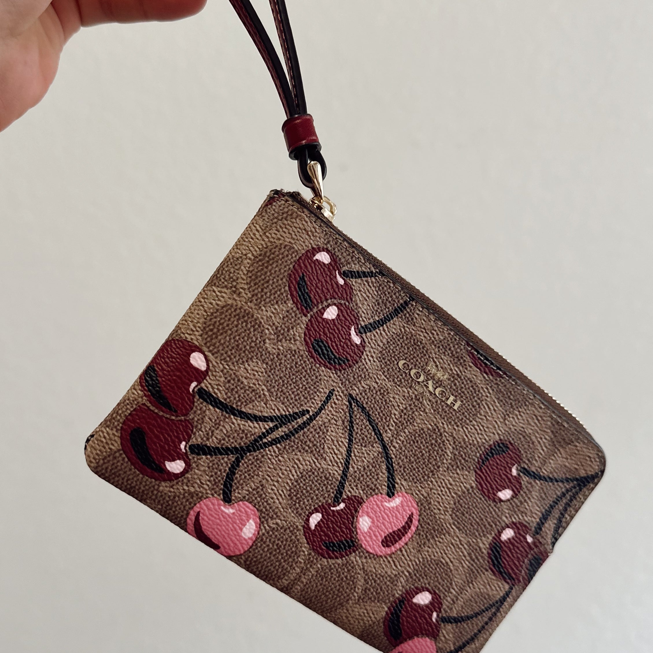 COACH CHERRY WRISTLET