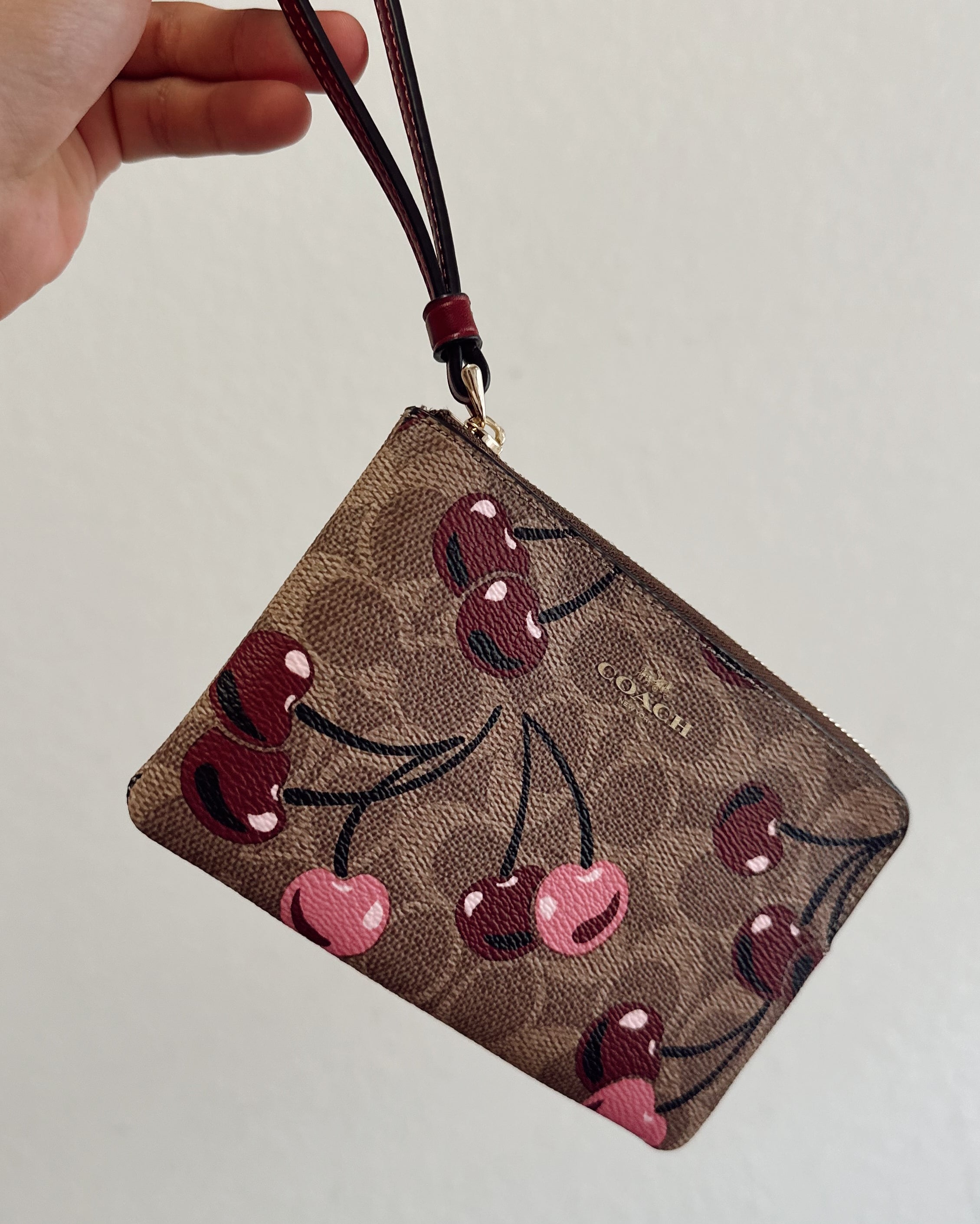 COACH CHERRY WRISTLET