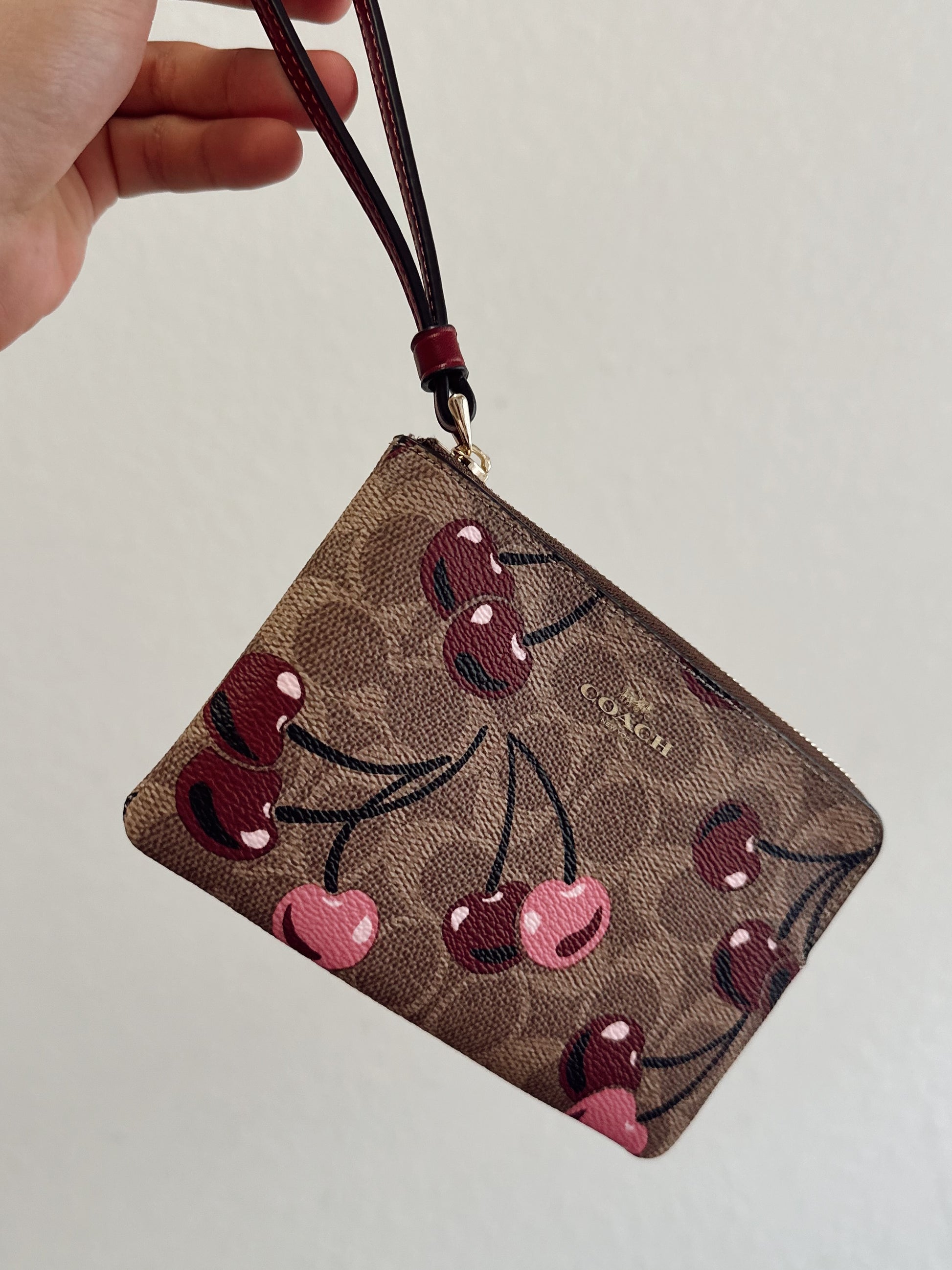 COACH CHERRY WRISTLET